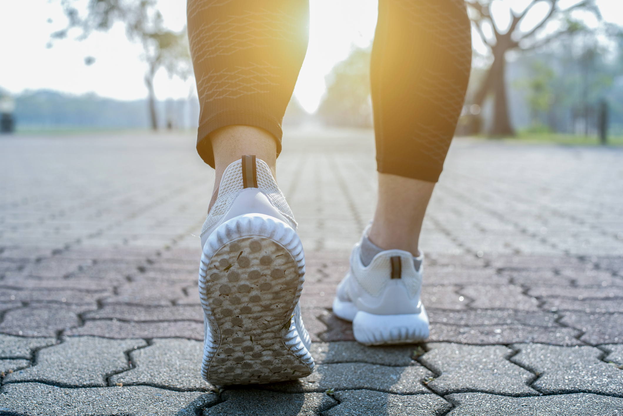 Woman walking on pavers in park