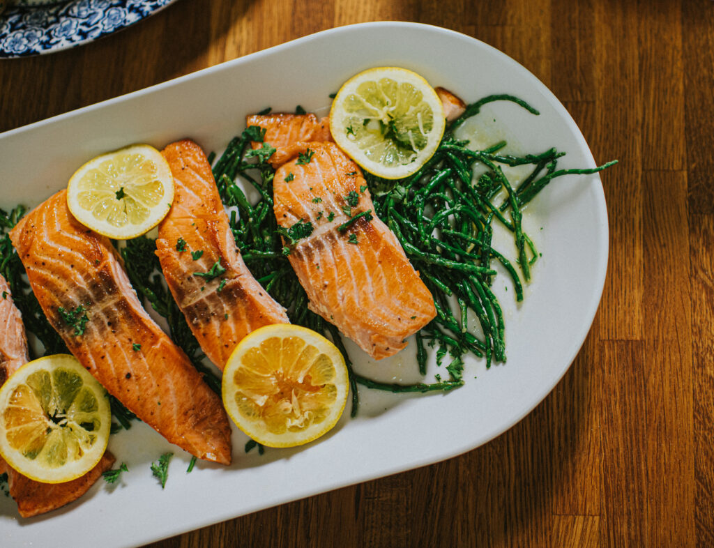 Salmon on platter with green vegetables