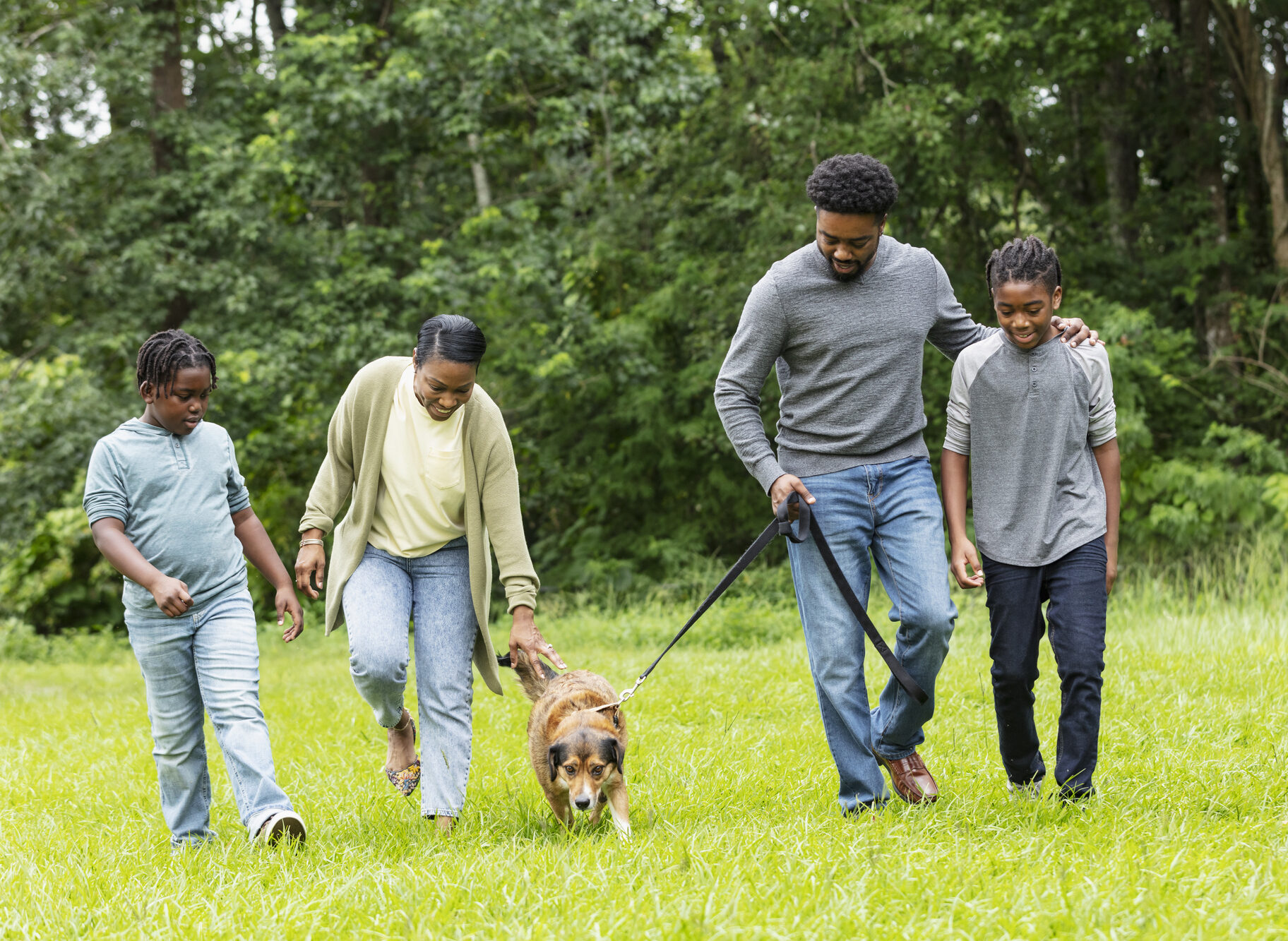 Family walking dog on leash