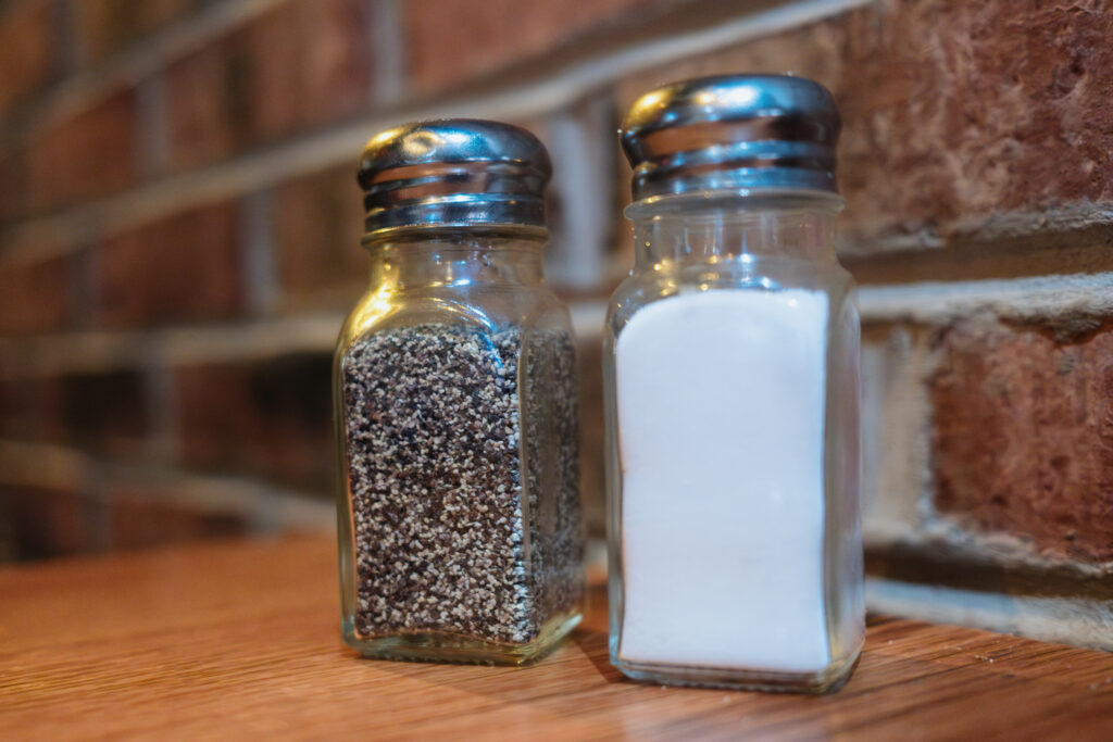 Salt and pepper shakers on table