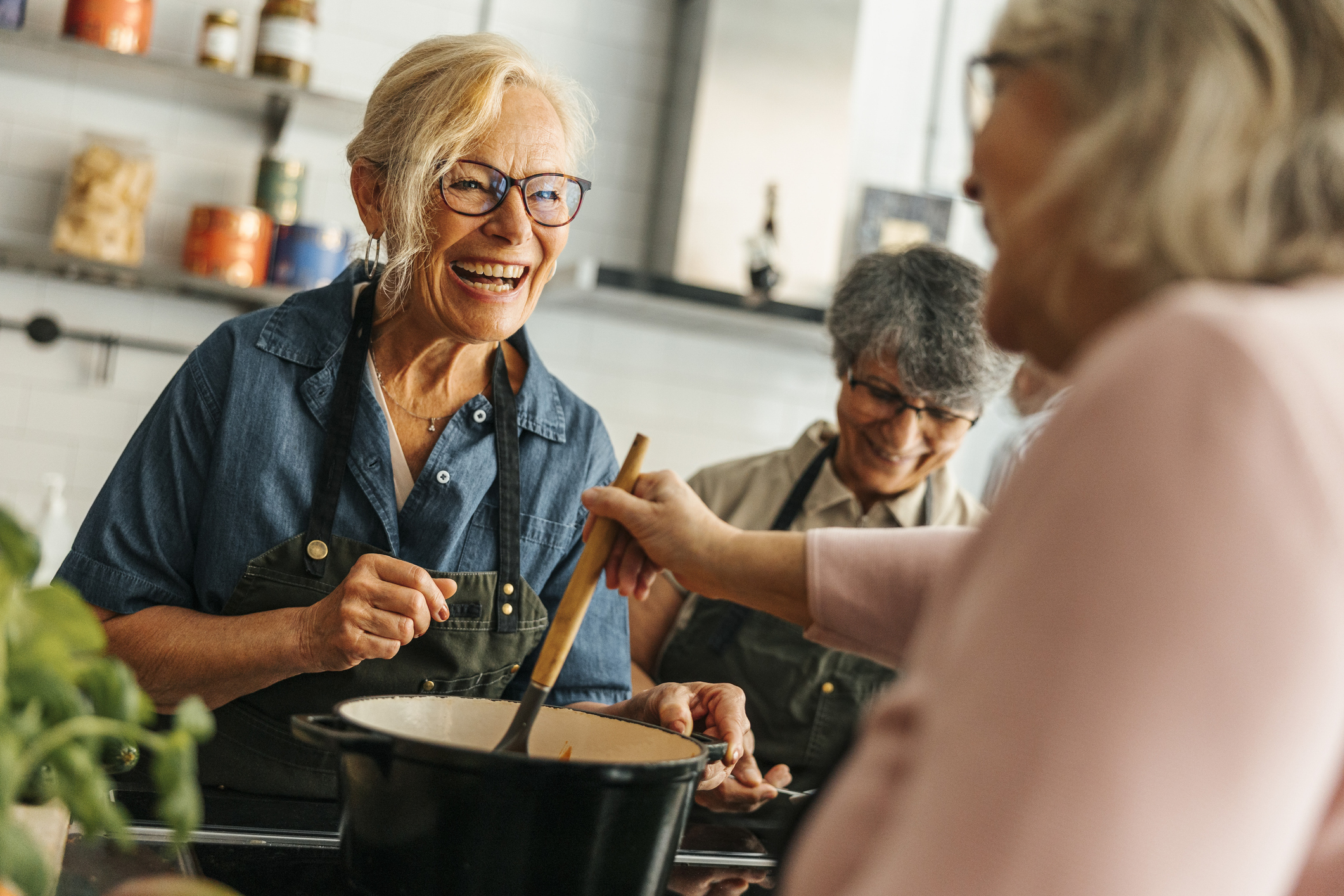 A group of older adults cooking a healthy meal together