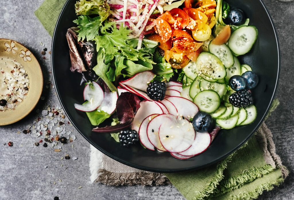Green salad with a variety of fruit and vegetables